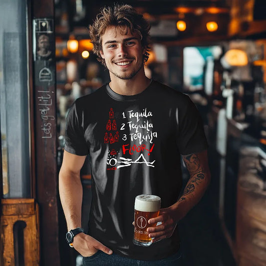 Man holding a beer in a bar wearing a black t-shirt with text. 1 Tequila 2 Tequila 3 Tequila Floor