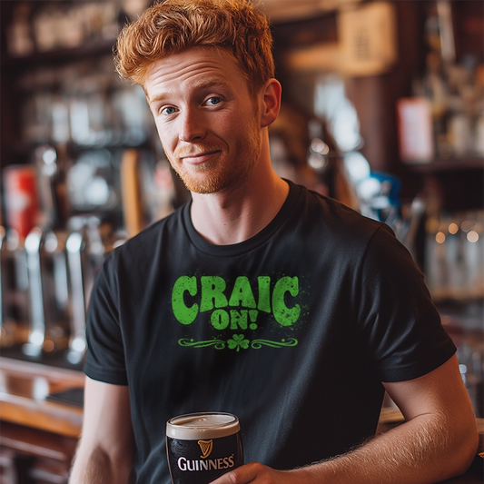 Man holding a Guinness beer mug in a bar wearing a black t-shirt with 'CRAIC ON!' text.