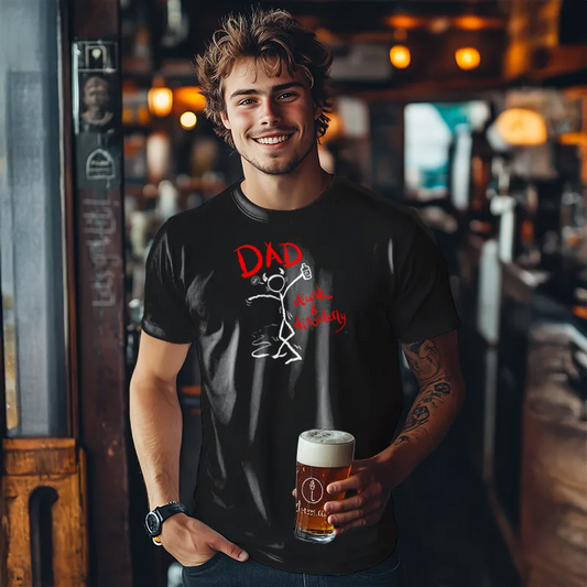 Man standing in a bar holding a beer and wearing a black t-shirt with a graphic design and text saying DAD Drunk and Disorderly