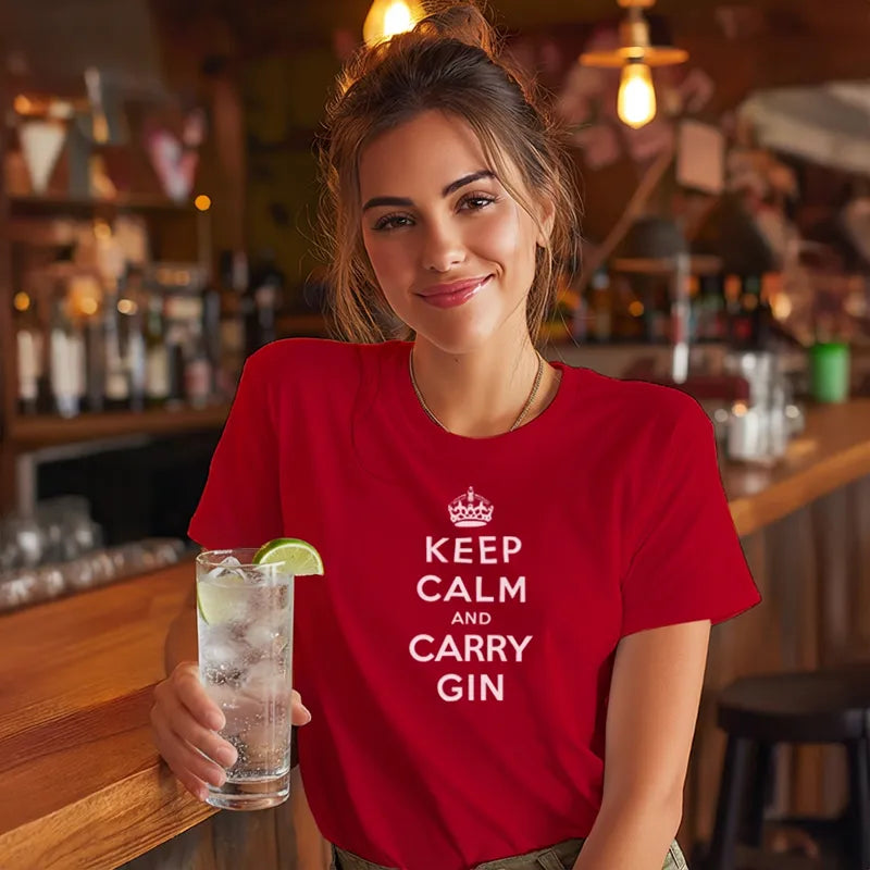 Girl in bar holding a gin and tonic and wearing a red t shirt with the text Keep Calm and Carry Gin