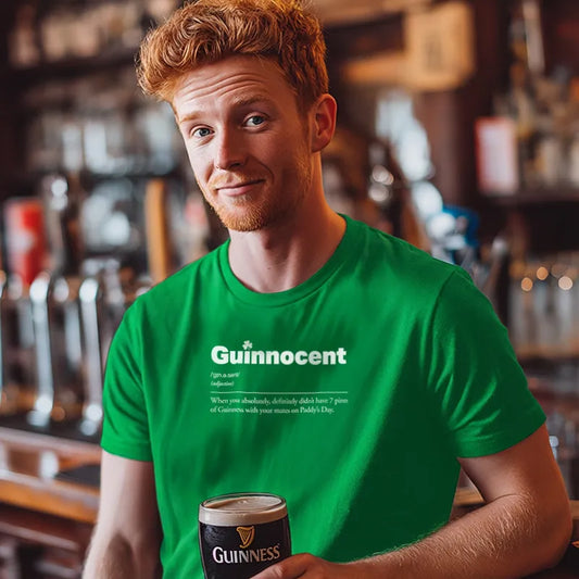 Man wearing a green 'Guintrovert' t-shirt holding a pint of Guinness in a bar setting.