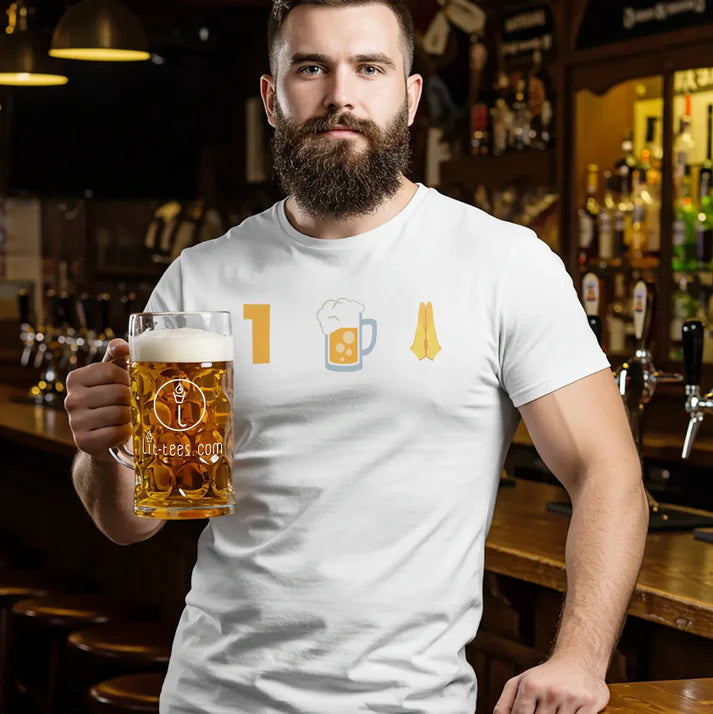 Man standing in a bar holding abeer and wearing a white t-shirt with a 1 Beer Please emoji graphic graphic 