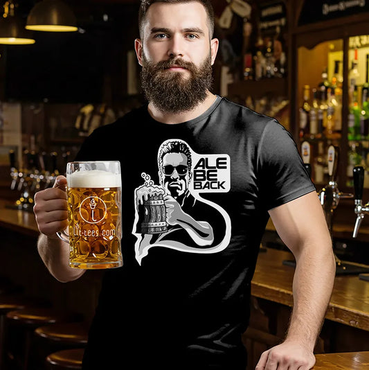 Man holding a beer in a bar wearing a black Terminator inspired t-shirt with the text 'Ale Be Back' 