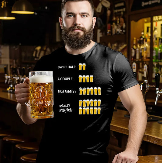 Man holding a beer mug in a bar wearing a black t-shirt with humorous beer maths text and graphics.