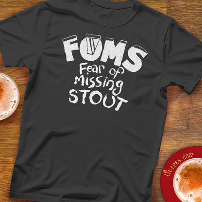 Black t-shirt with 'FOMS Fear of Missing Stout' text on a wooden bar table