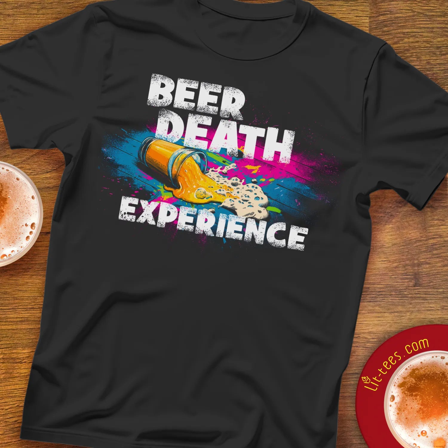 Black t-shirt with colorful graphic and text 'Beer Death Experience' on a wooden bar table