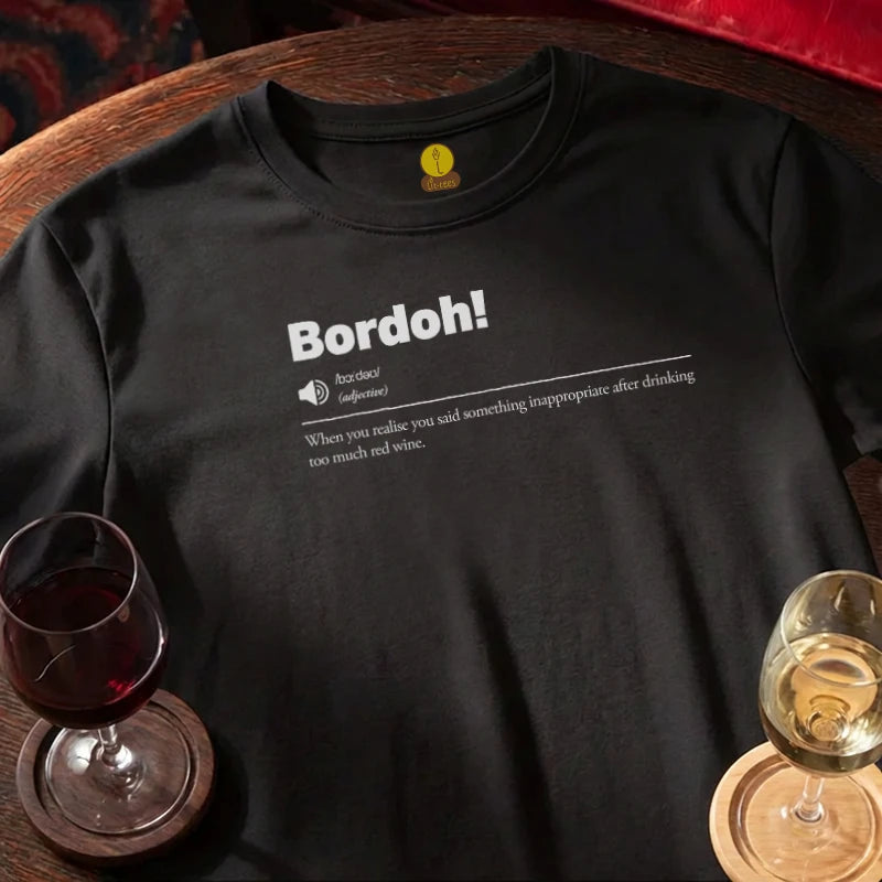 Black t-shirt with 'Bordoh!' definition text, and wine glasses on a wooden bar table.
