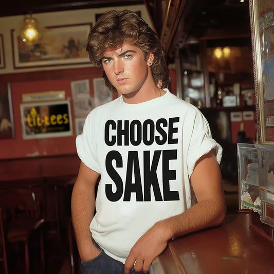 Wham lookalike wearing a white t-shirt with 'CHOOSE SAKE' text in a bar setting