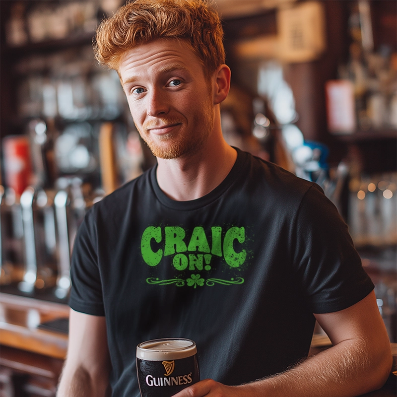 Man holding a Guinness beer mug in a bar wearing a black t-shirt with 'CRAIC ON!' text.