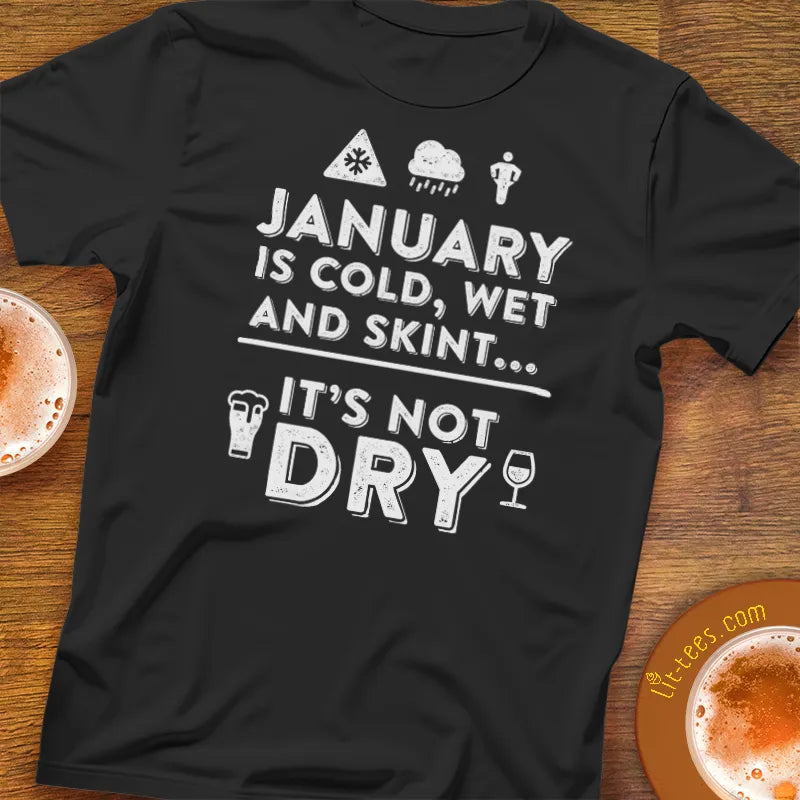 Black t-shirt with humorous text design on a wooden surface with drinks.