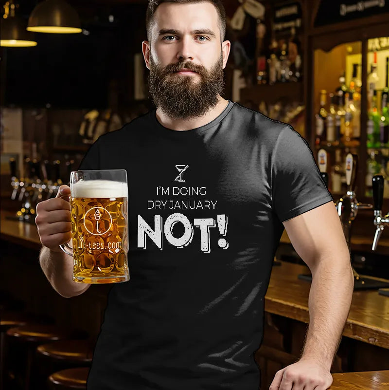 Man in a bar holding a beer wearing a black t-shirt with 'I'm doing Dry January Not!' text  