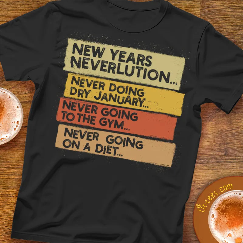 Black t-shirt with humorous New Year's Neverlution text on a wooden bar table with drinks