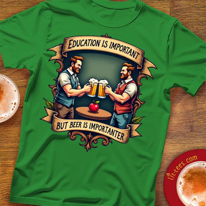 Green t-shirt with graphic of two men holding beer mugs and text 'Education is important but beer is importanter' on a wooden surface.