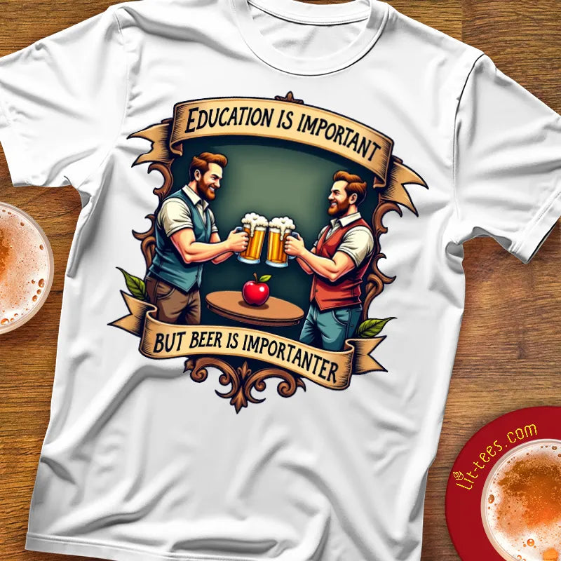 White t-shirt with graphic design of two men holding beer mugs and an apple, with text 'Education is important but beer is importanter' on a wooden surface.