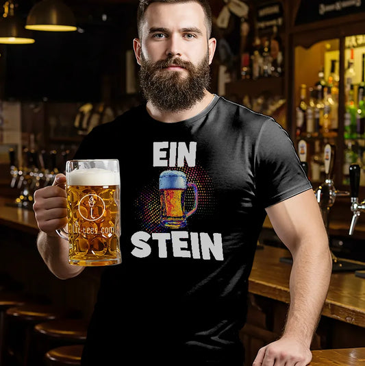 Man in a bar wearing a black t-shirt with humourous text saying 'EIN STEIN' holding a beer glass.