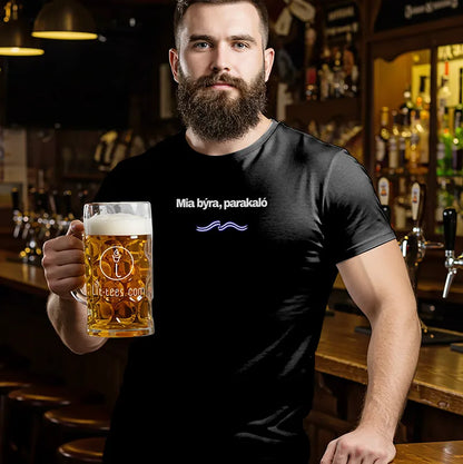 Man in a bar holding a beer mug and wearing a black t-shirt with text saying One Beer Please in Greek 