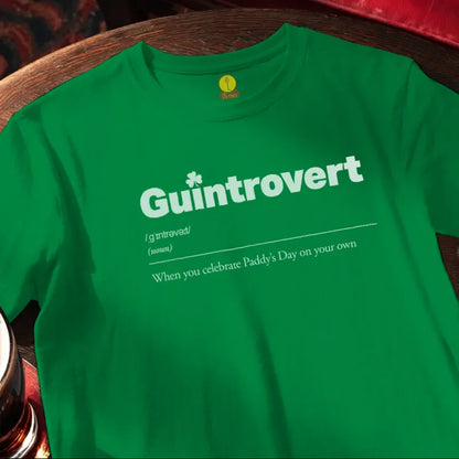 Green t-shirt with 'Guintrovert' text on a wooden bar surface