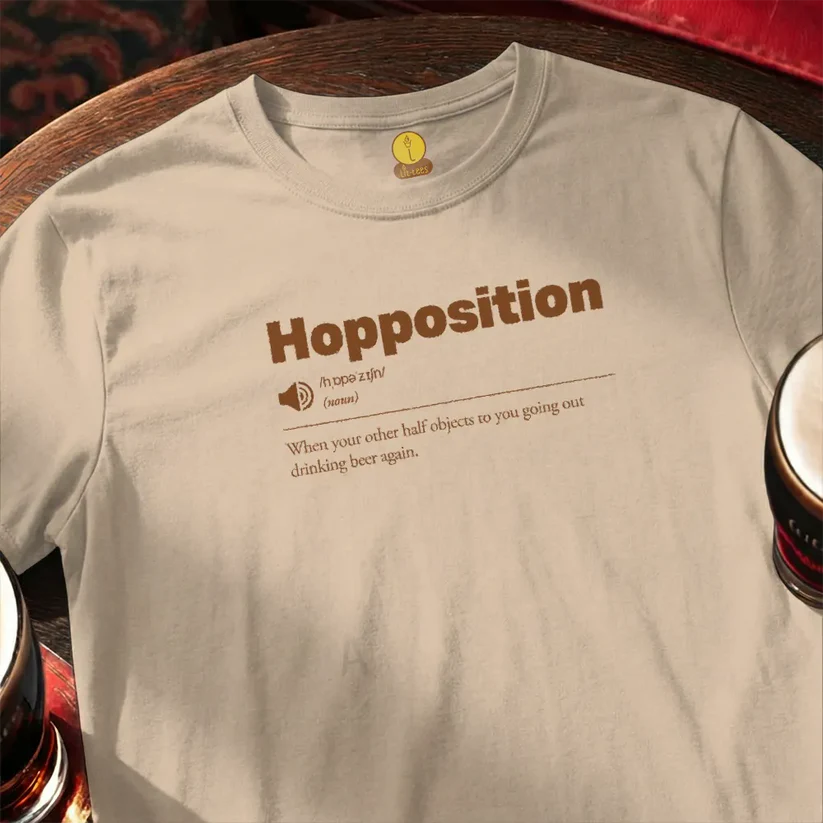 Beige t-shirt with 'Hopposition' text and beer glasses on a wooden surface