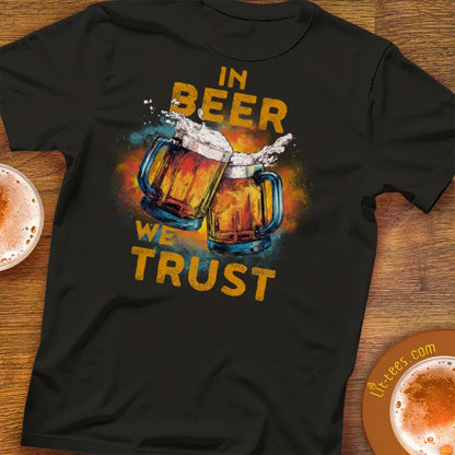 Black t-shirt with 'In Beer We Trust' graphic on a wooden bar table
