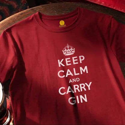 Red t-shirt with 'Keep Calm and Carry Gin' text on a wooden bar table