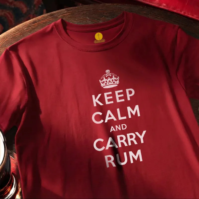 Red t-shirt with 'Keep Calm and Carry Rum' text on a wooden bar surface.