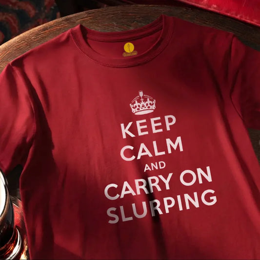 Red T Shirt with text saying Keep Calm and Carry on Slurping on a wooden bar table