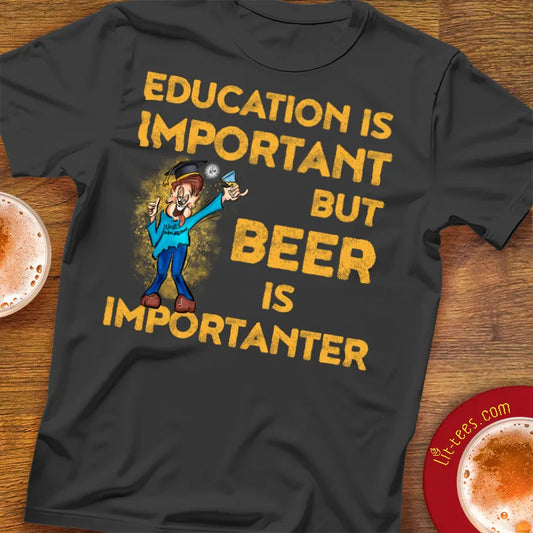 Black t-shirt with humorous text saying 'Education is important but beer is importanter' on a wooden bar table