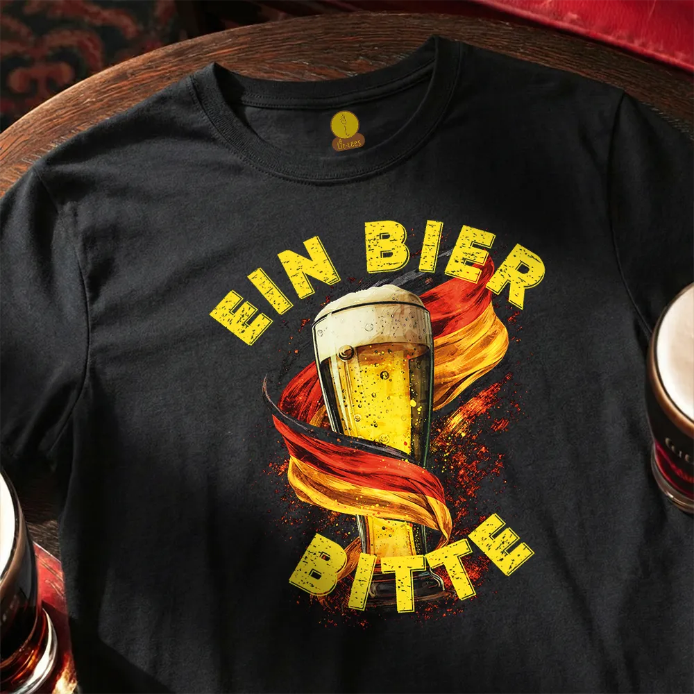 Black t-shirt with a graphic of a beer glass and text 'EIN BIER BITTE' on a wooden surface.