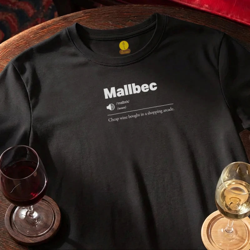 Black t-shirt with 'Mallbec' text design, wine glass, and glass of white wine on a wooden bar table.
