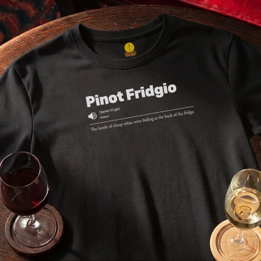 Black t-shirt with 'Syrahhhhhh' text on a wooden bar surface with wine glasses.