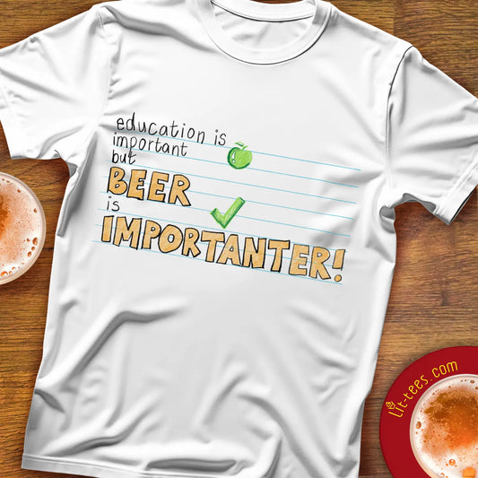 White t-shirt with humorous text saying 'Education is important but beer is importanter' on a wooden bar table